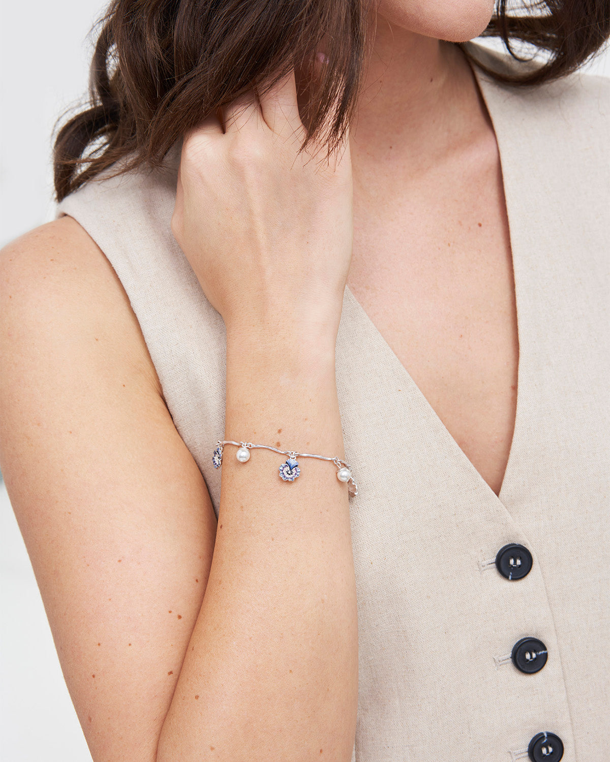 model wearing silver pansy and pearl charm bracelet