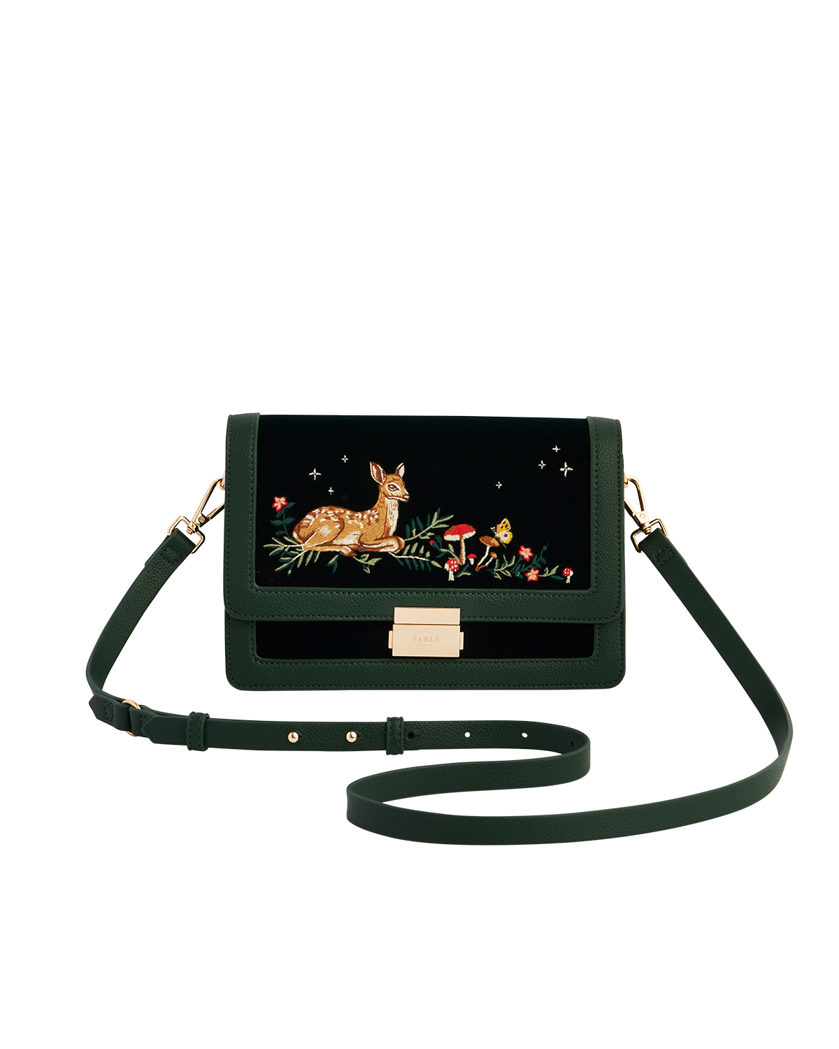 Green handbag with a fawn and mushroom design on a black background