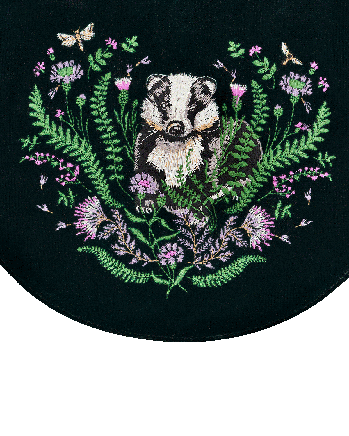 Embroidered design of a badger surrounded by flowers and leaves on a green background