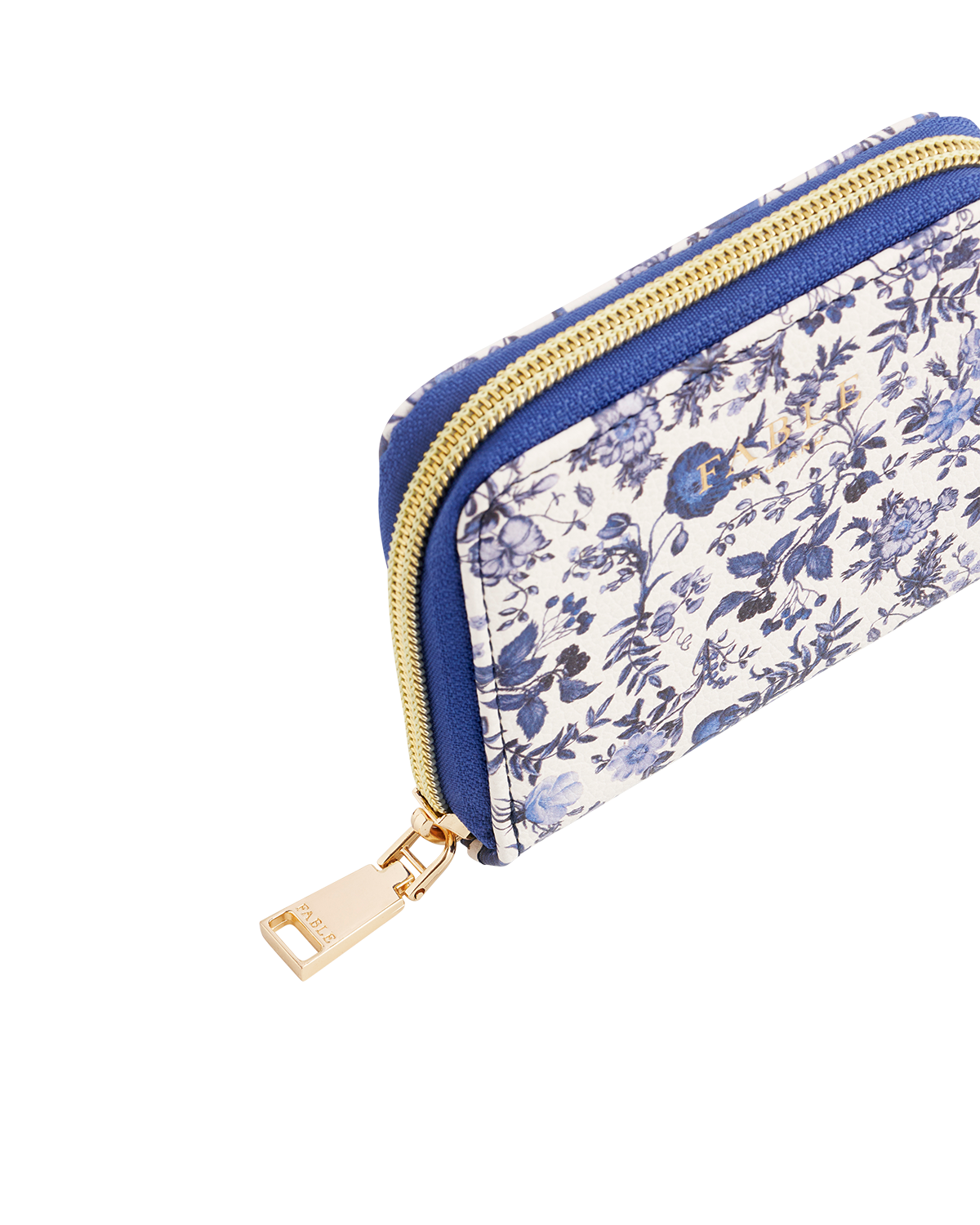 Blue floral-patterned purse with a blue zipper on a white background