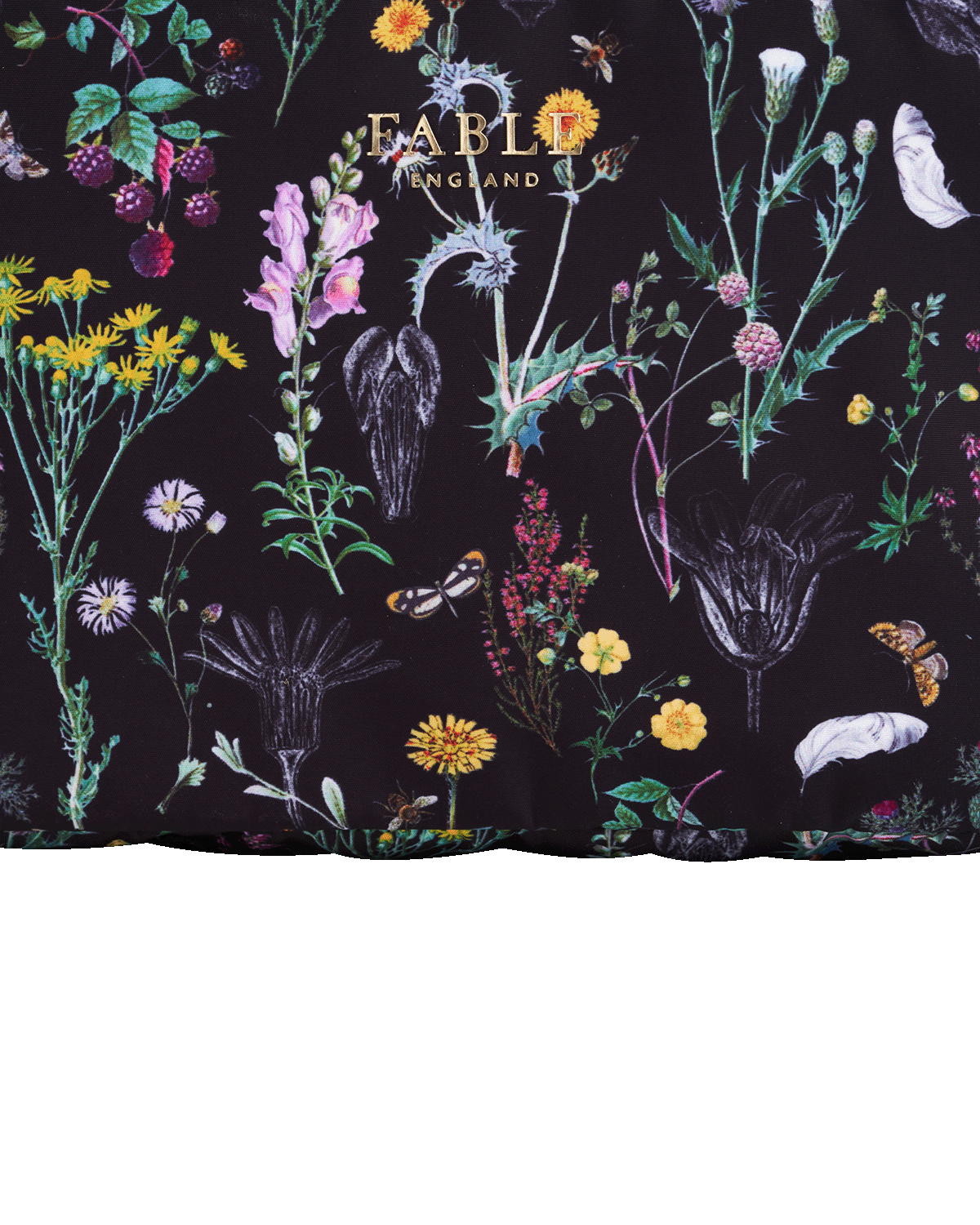 Close up of toiletry bag with floral and botanical design on a black background, featuring the brand 'Fable England'.