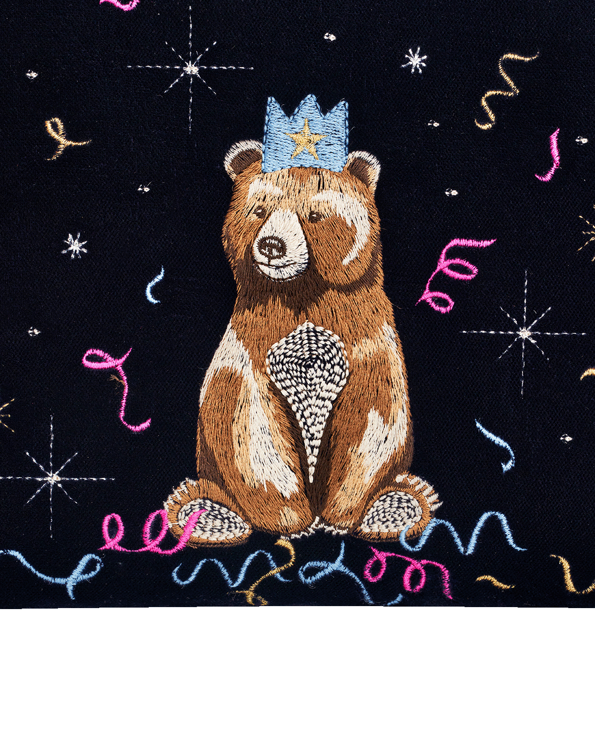 Embroidered bear with a crown on a blue background with decorative elements