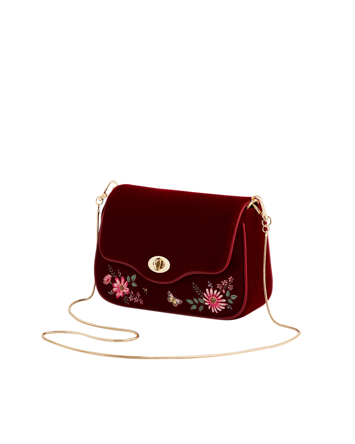 Red velvet handbag with floral embroidery and a gold chain strap on a white background