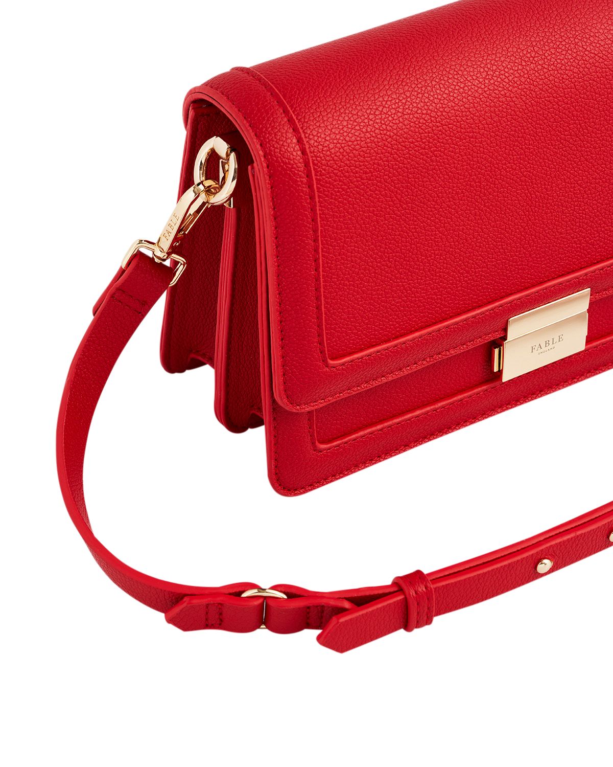 Red handbag with gold accents on a white background
