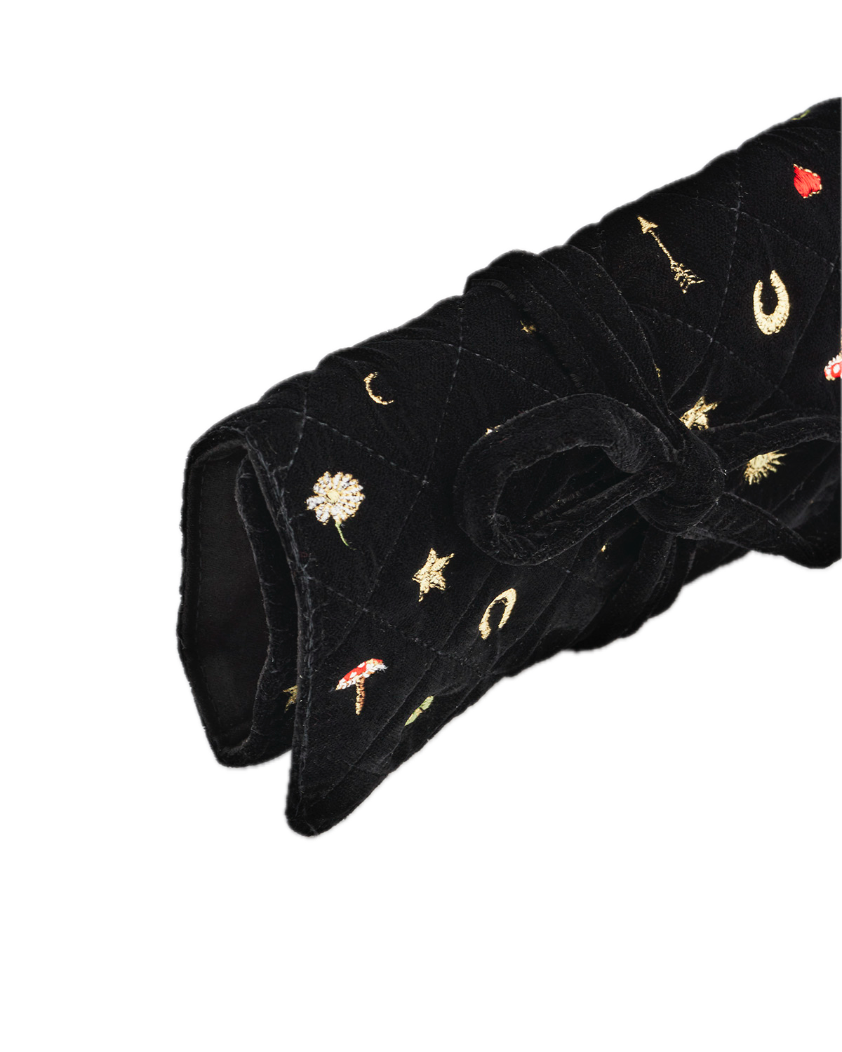 Black velvet jewellery roll with embroidered designs on a white background