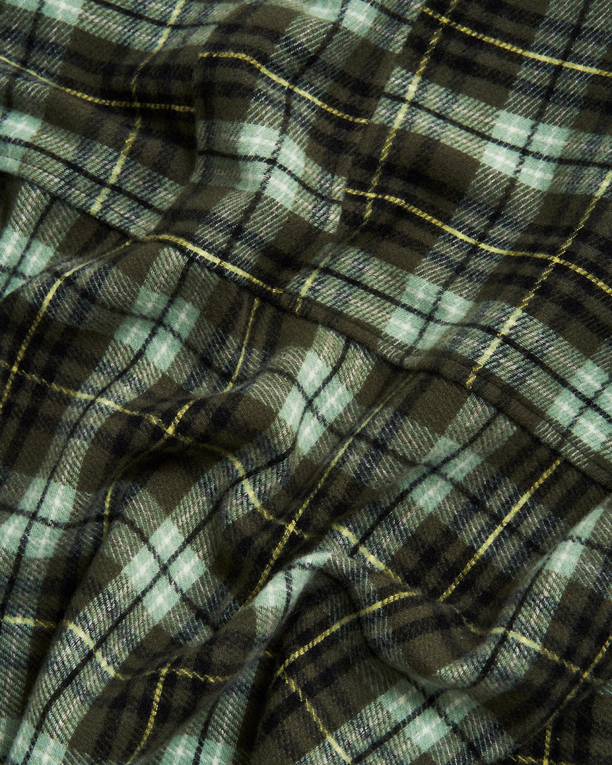 Close-up of plaid fabric with green and brown colors