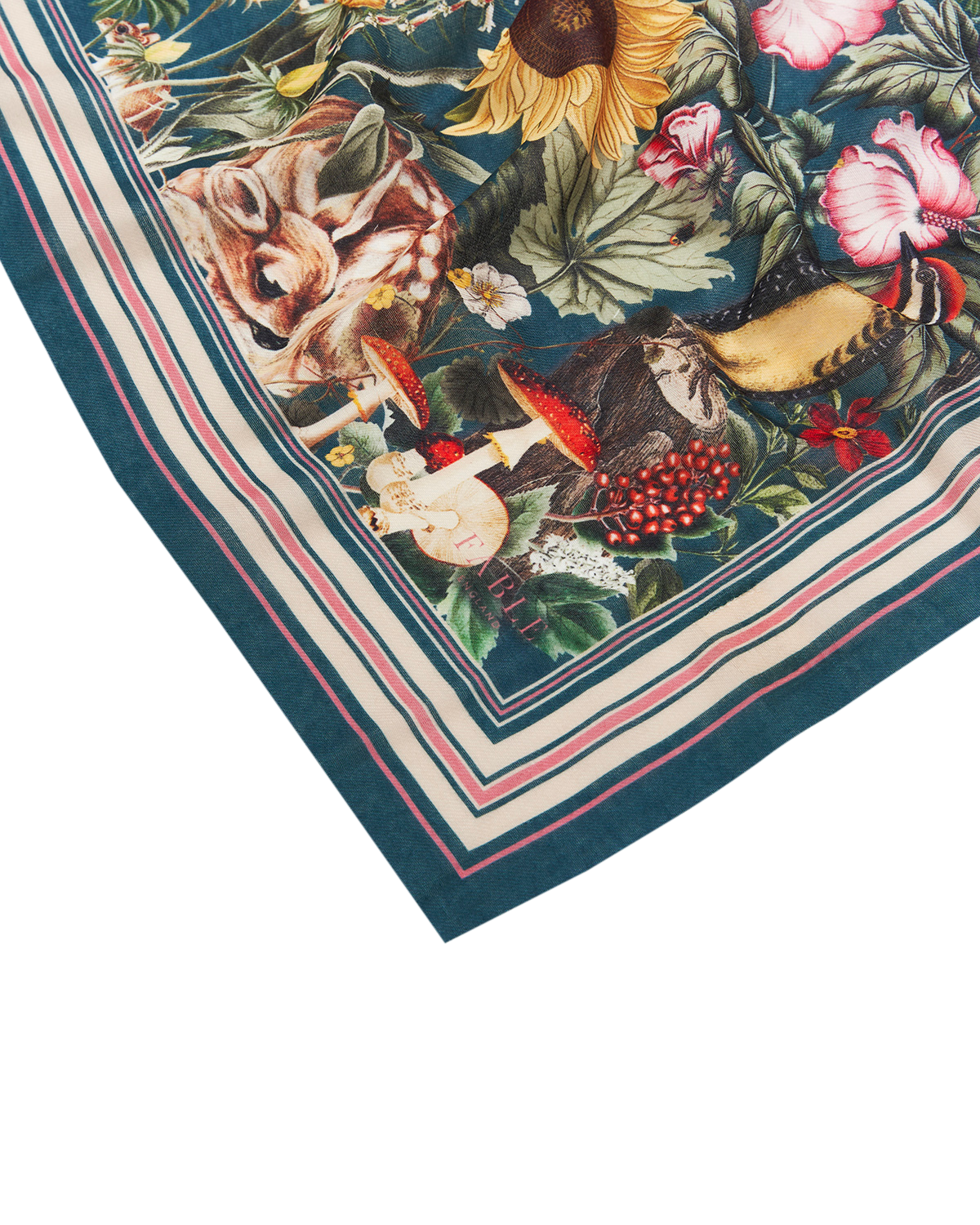 close up of scarf with floral and animal design on a white background