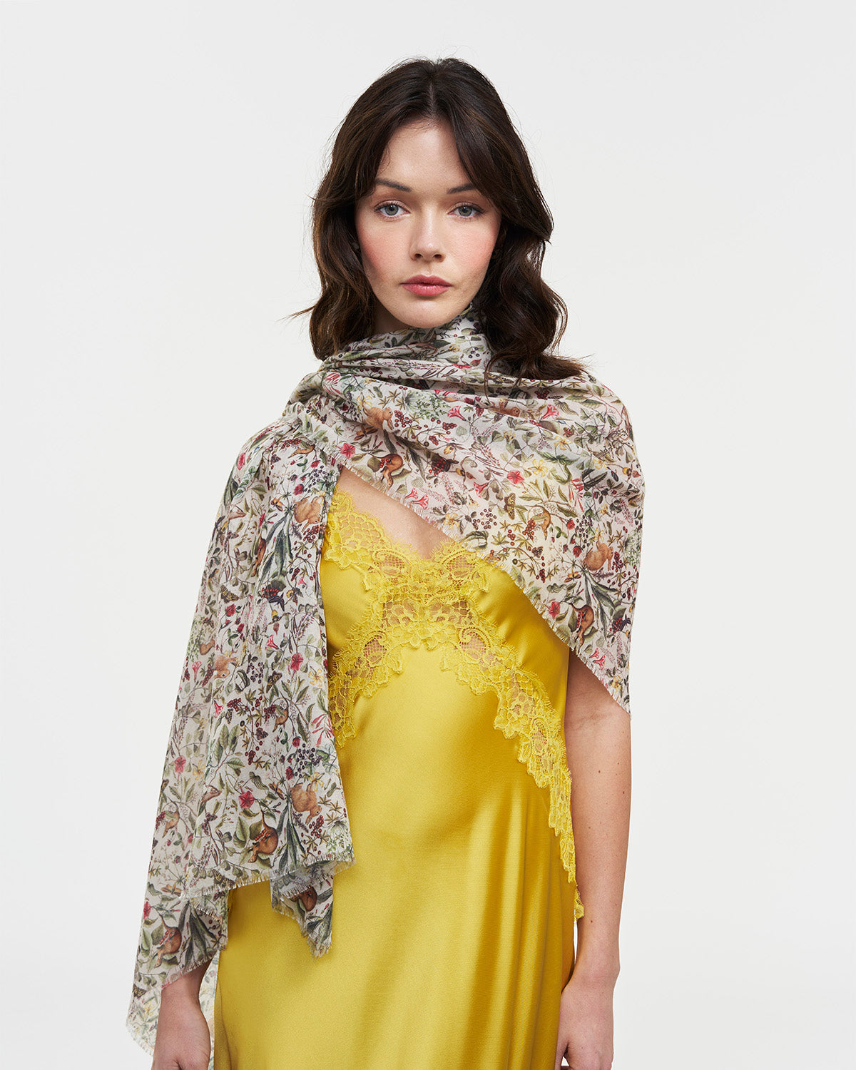 Model showcasing the Cream Garden Floral Lightweight Long Scarf, styled elegantly over a yellow dress.