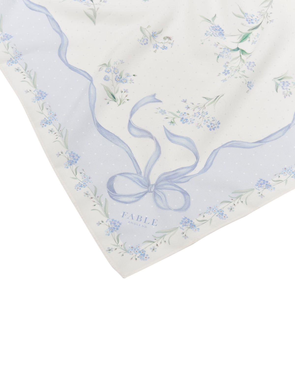 Floral patterned fabric with a blue ribbon design on a white background
