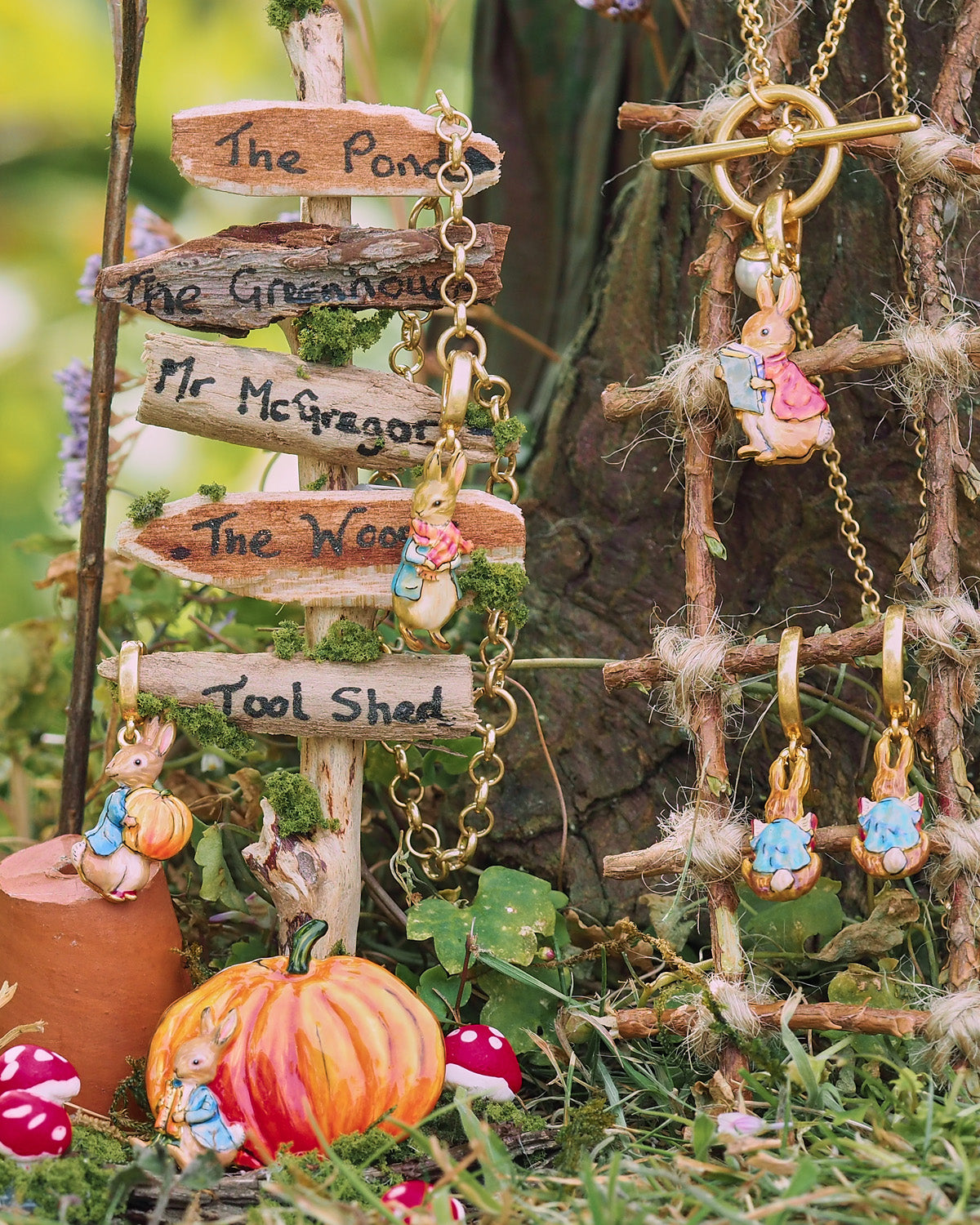 Miniature garden scene with wooden signs and Peter Rabbit characters in a natural setting