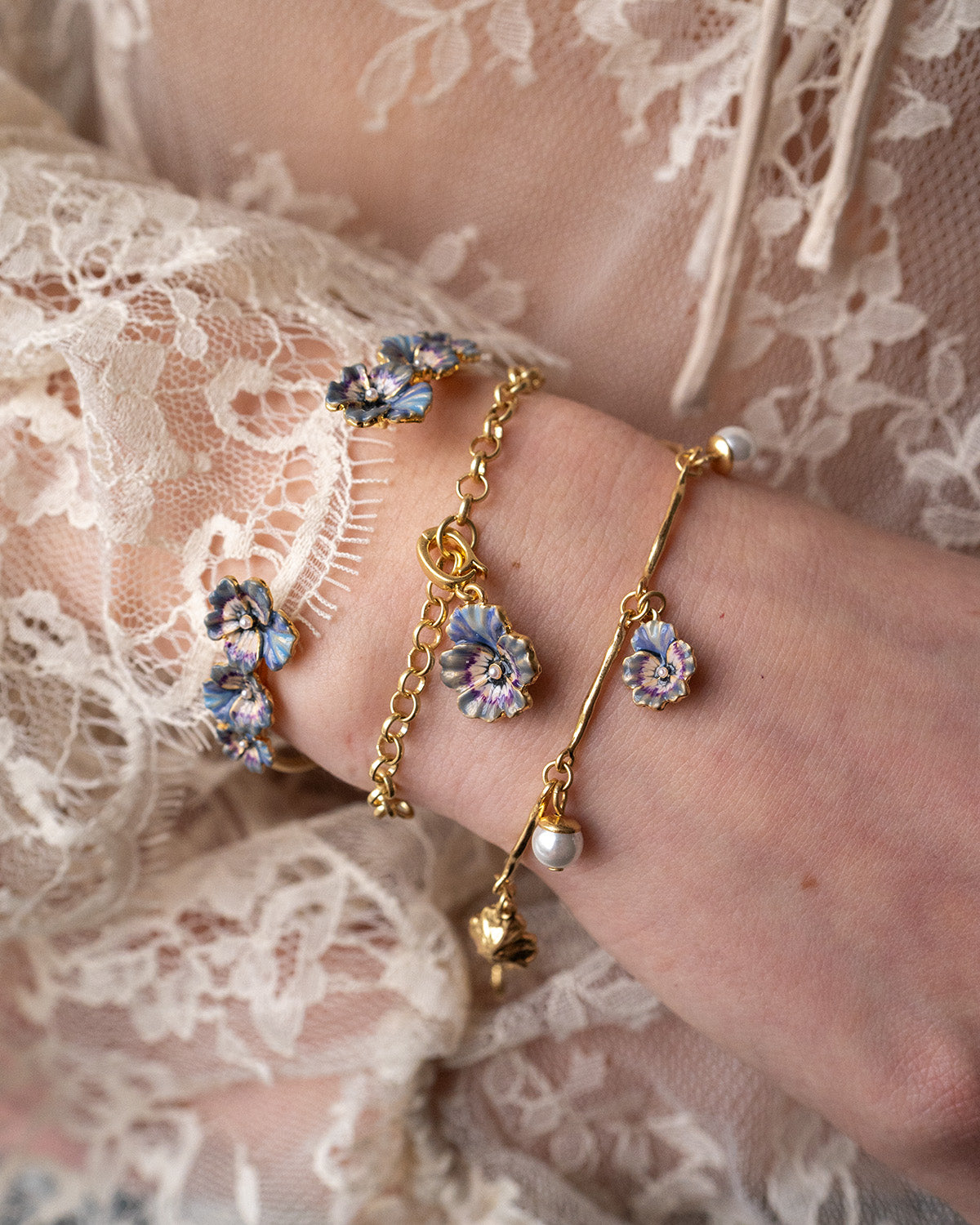 Gold Pansy & Pearl Collector Charm Bracelet featuring floral designs and pearl accents, showcasing elegance and charm.