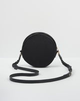 Back of embroidered sleepy fox motif on navy circle crossbody bag. Back is plain.