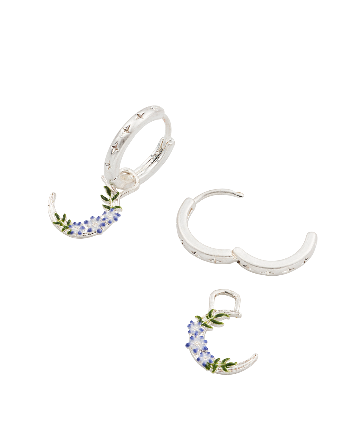 Set of silver huggie earrings with floral moon design on a white background