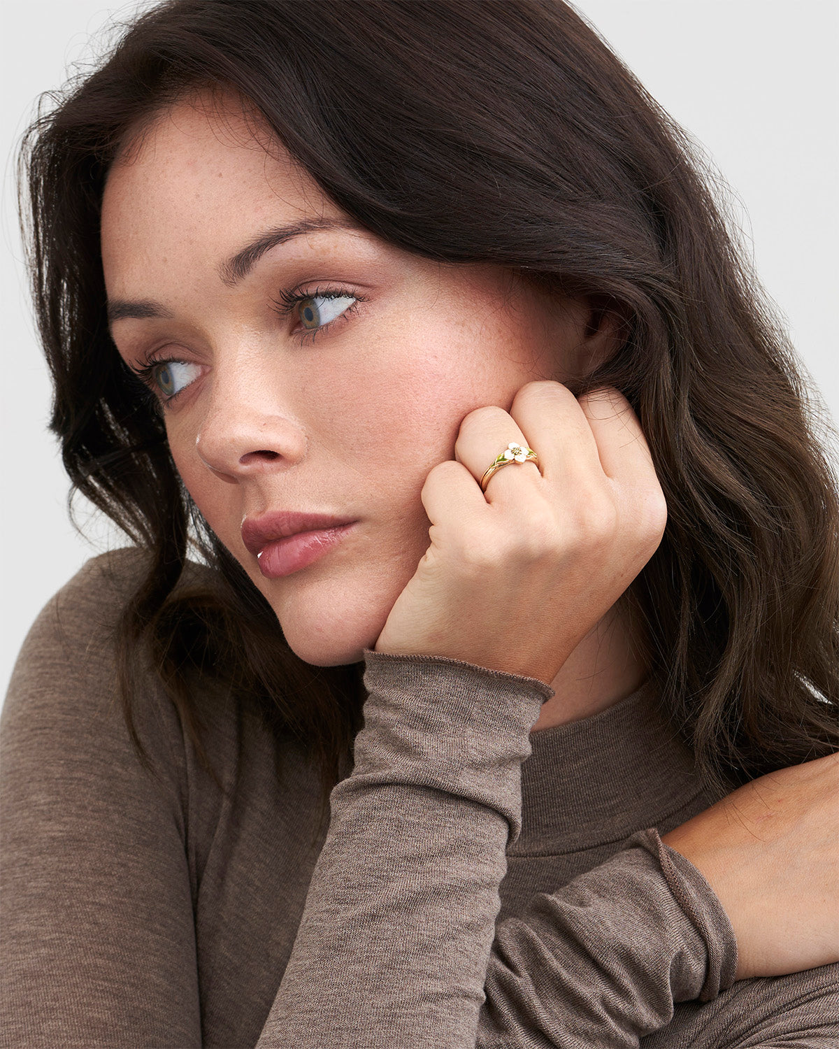 Woman wearing a ring with a neutral background