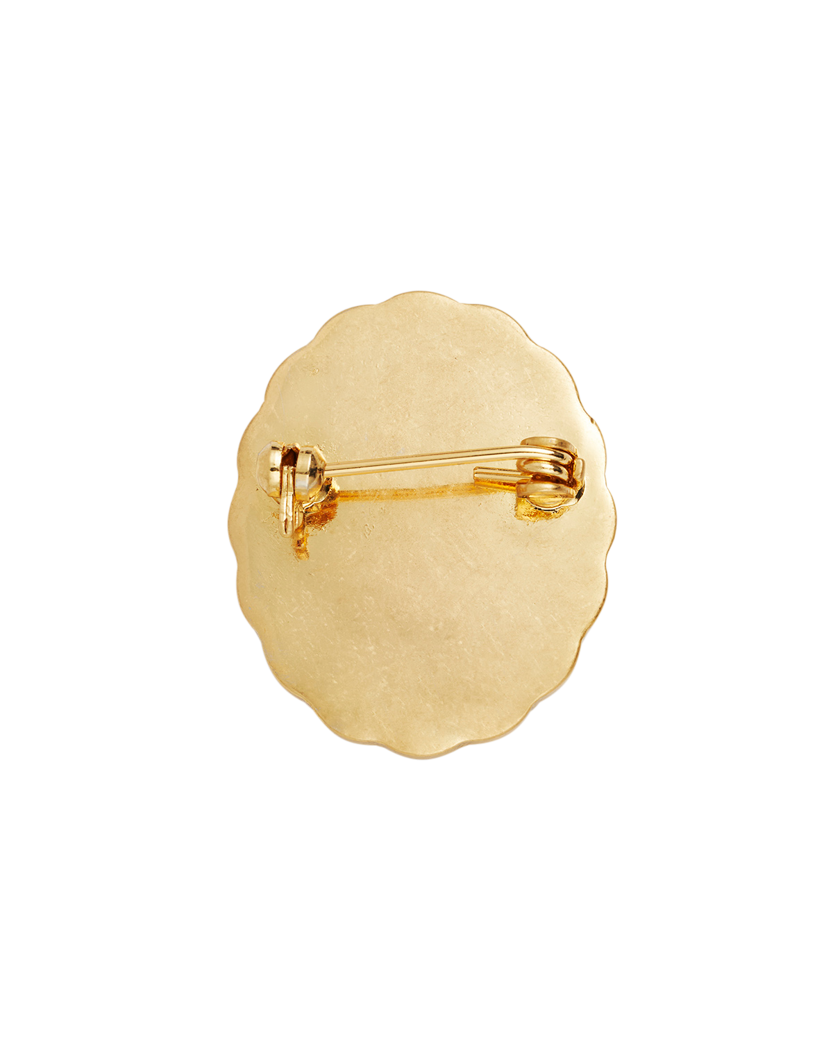 Gold brooch with scalloped edge on a white background