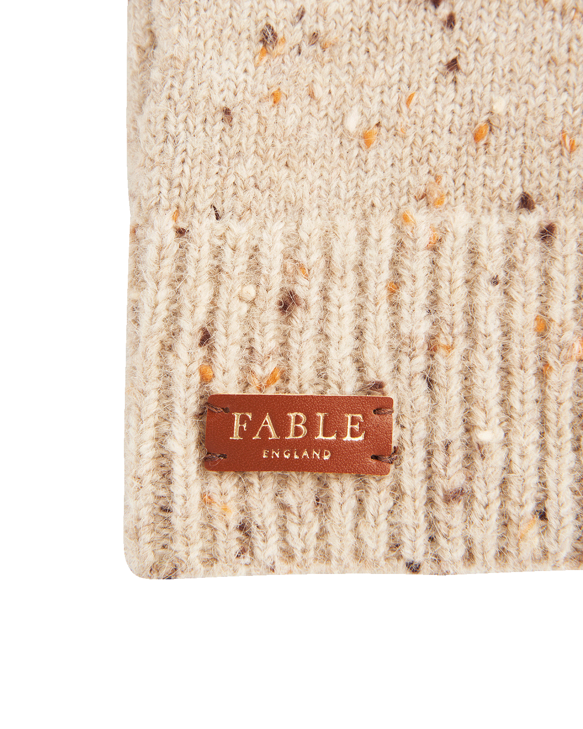 Beige knitted fingerless gloves with 'Fable England' label on a white background