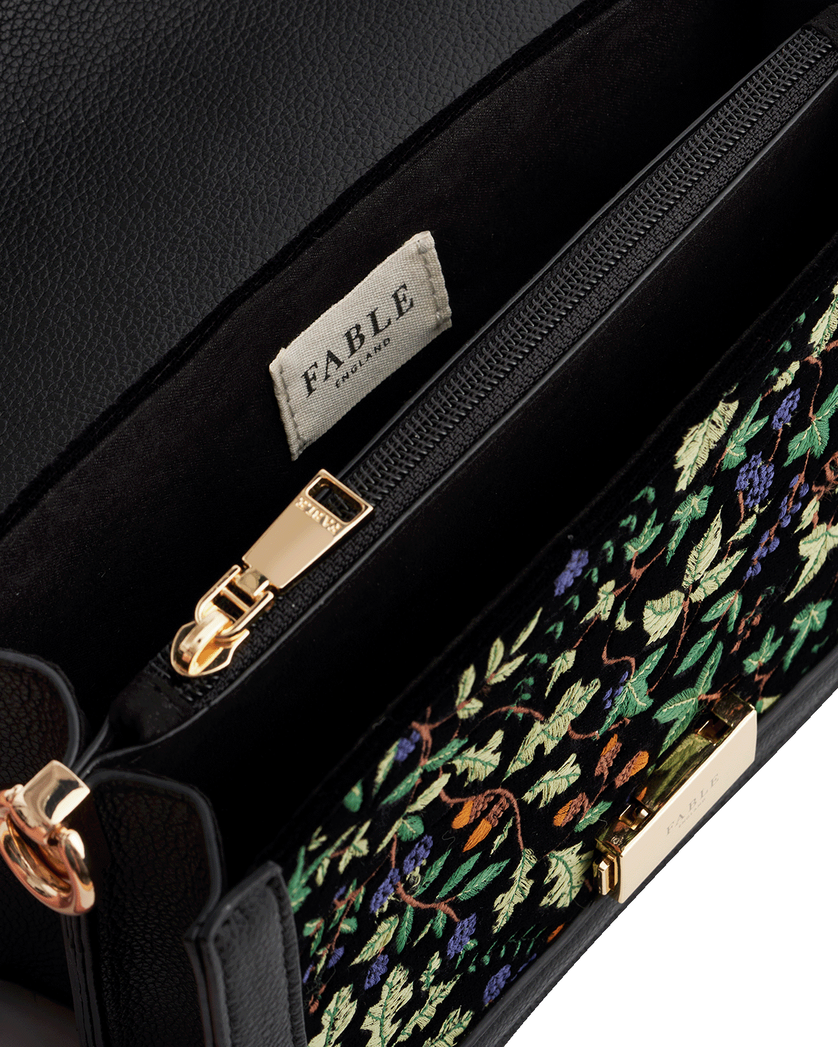 Black handbag with oak leaf embroidery and 'Fable England' brand label