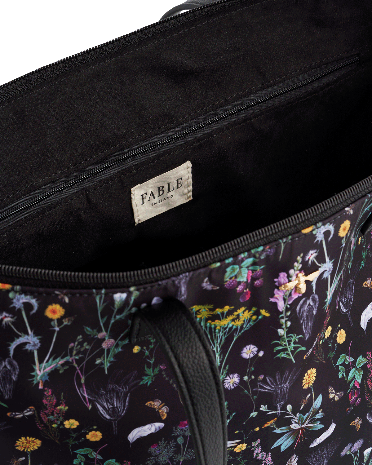 Floral-patterned bag with 'Fable England' brand label on a white background