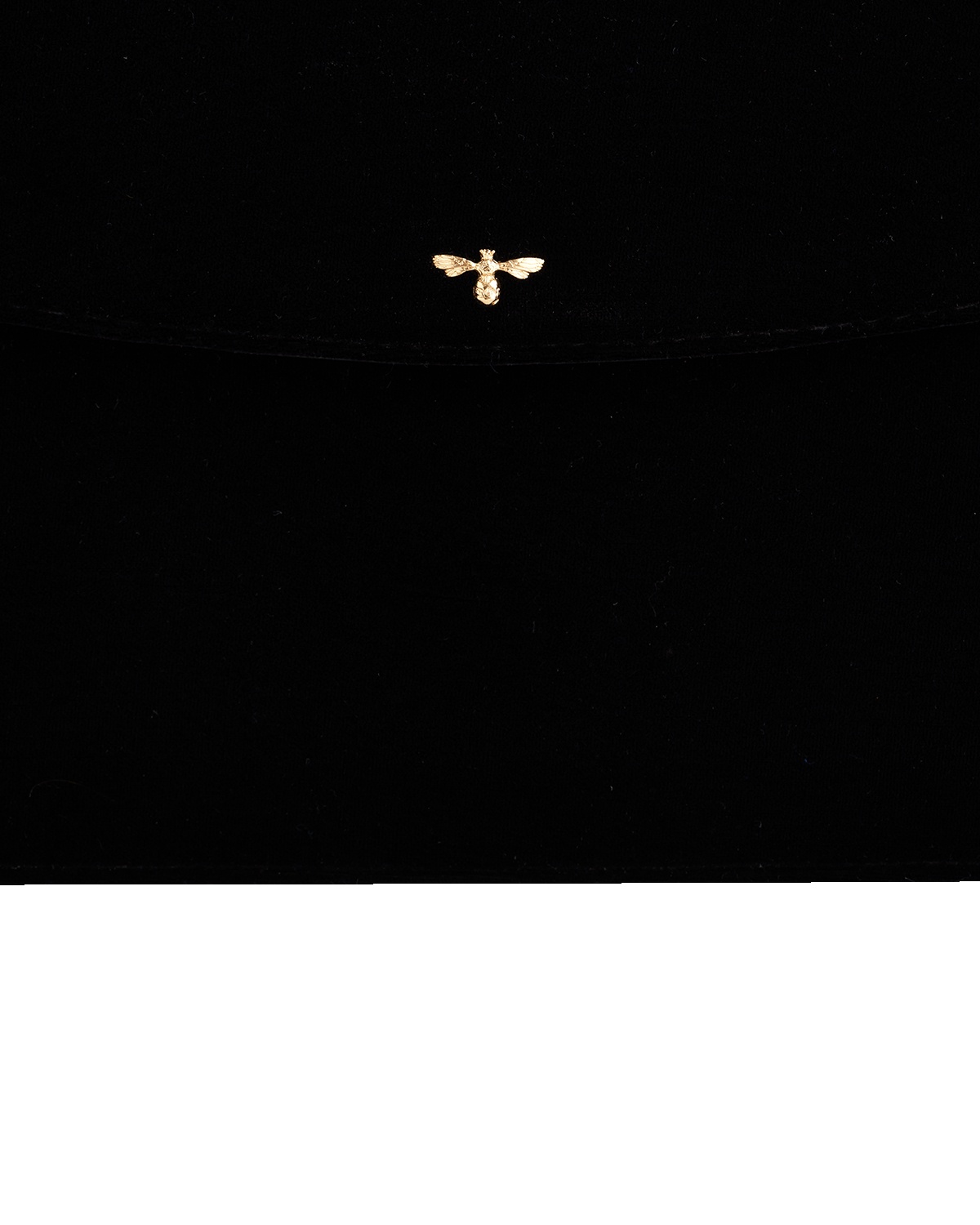 Small gold bee pendant on a black background