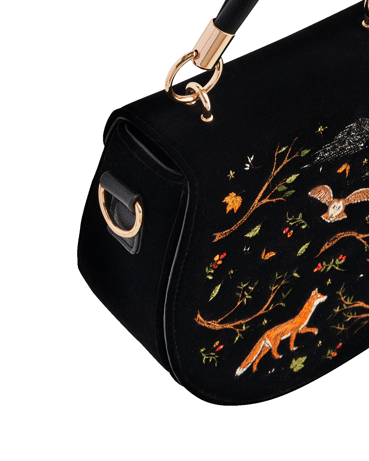 Black handbag with fox and nature-themed embroidery on a white background