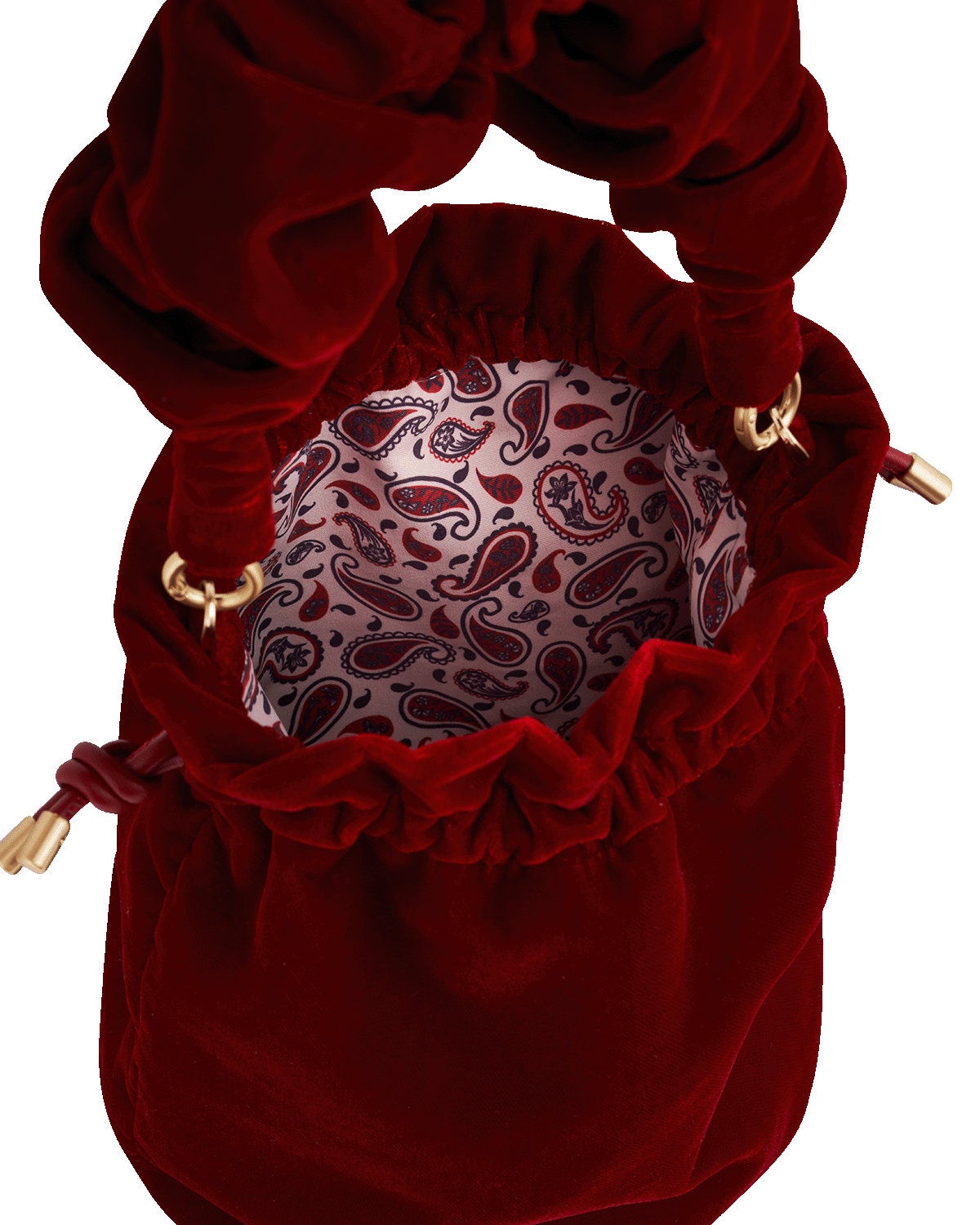 Red velvet drawstring bag with paisley pattern interior on a white background