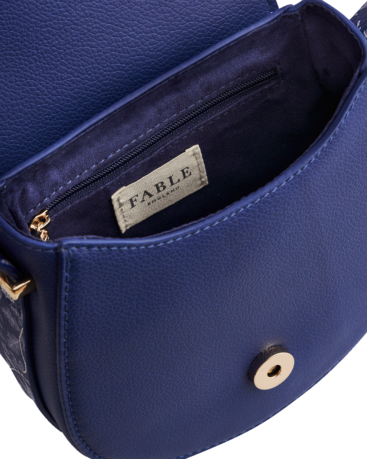 Blue leather handbag with 'Fable England' brand label on a white background
