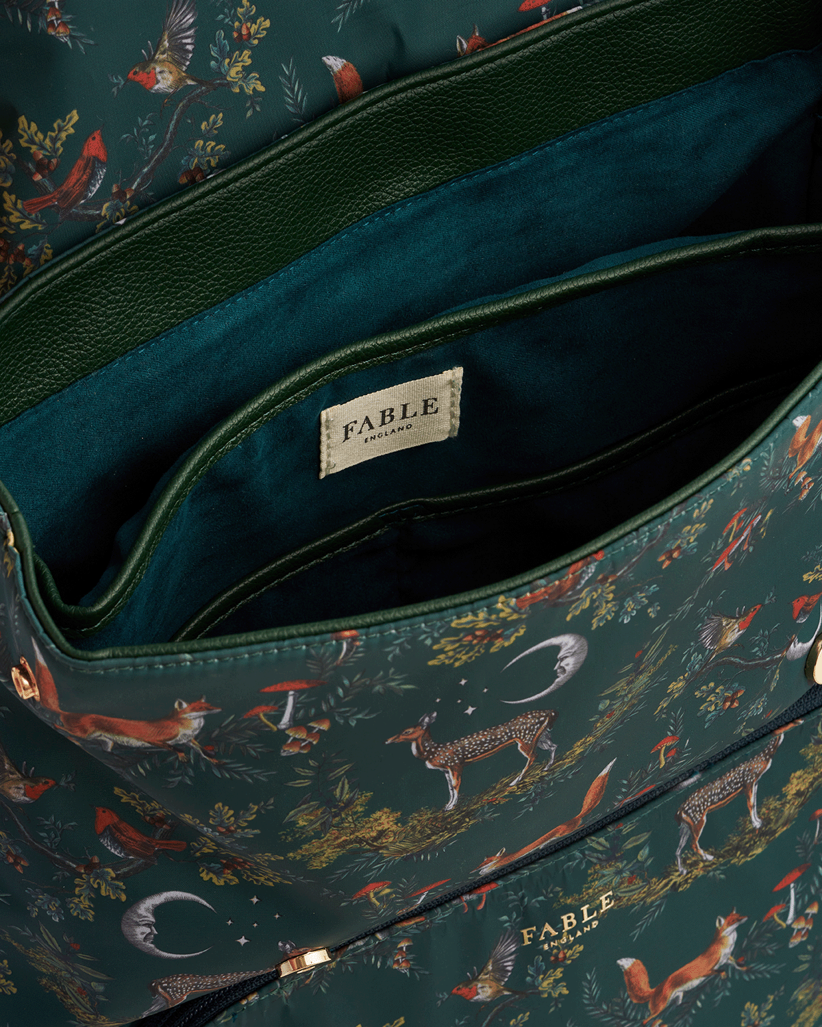 Green woodland patterned backpack with Fable England branding