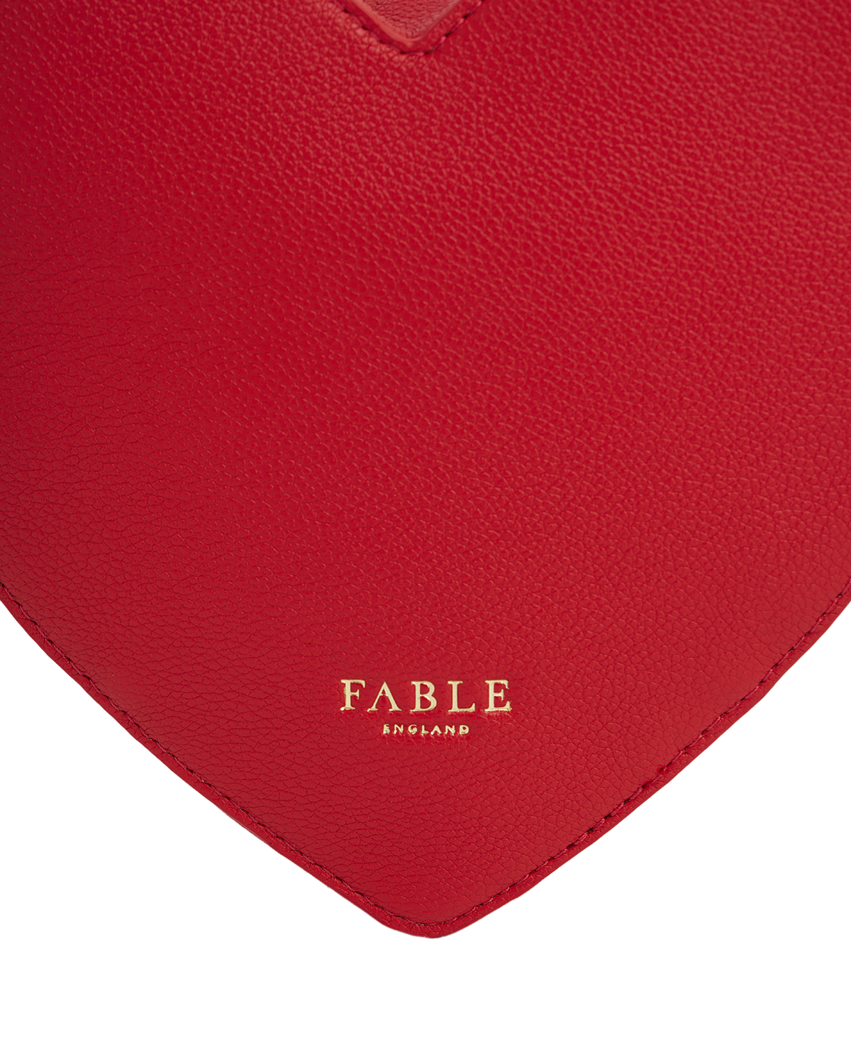 Red faux leather heart bag with 'Fable' branding on a white background