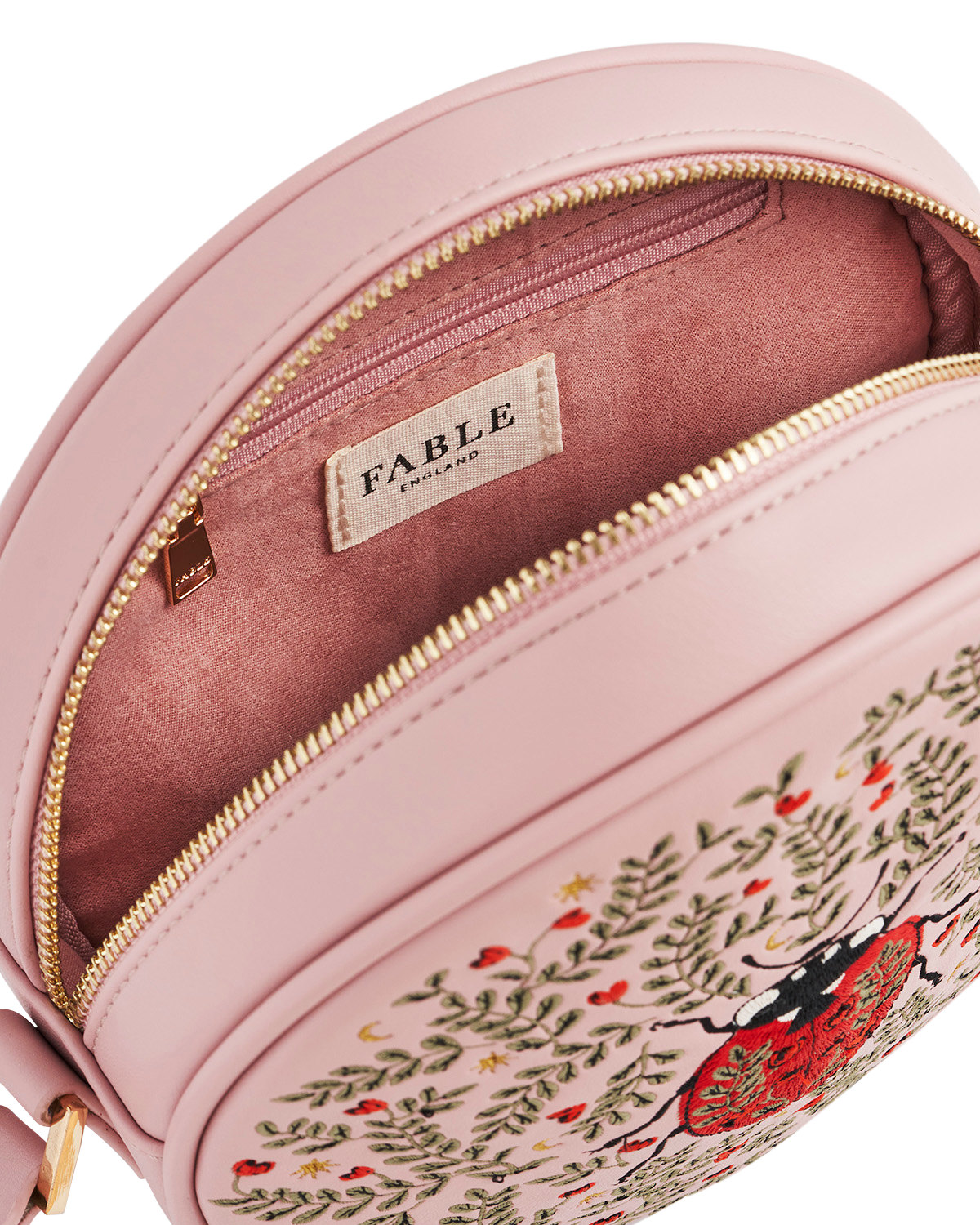 Pink bag with embroidered design and 'Fable' brand label on a white background