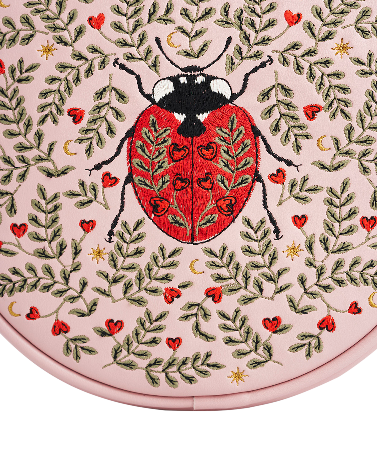 Embroidered ladybug design on a pink background with leaves and hearts.