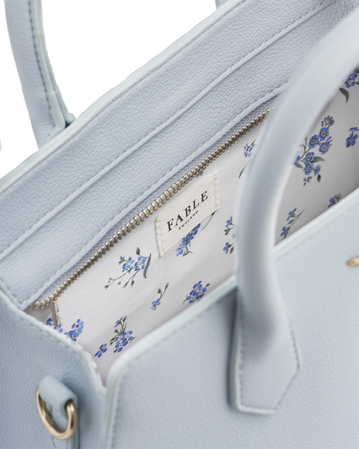 Light blue handbag with floral interior lining and 'Fable' brand label.