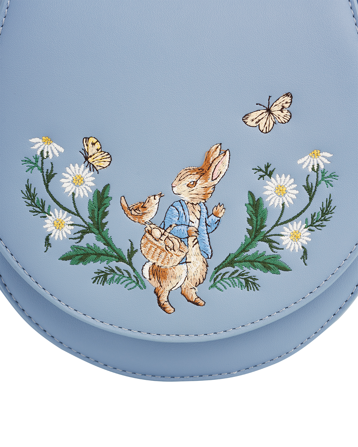 Light blue bag with embroidered design of a rabbit, flowers, and butterflies.