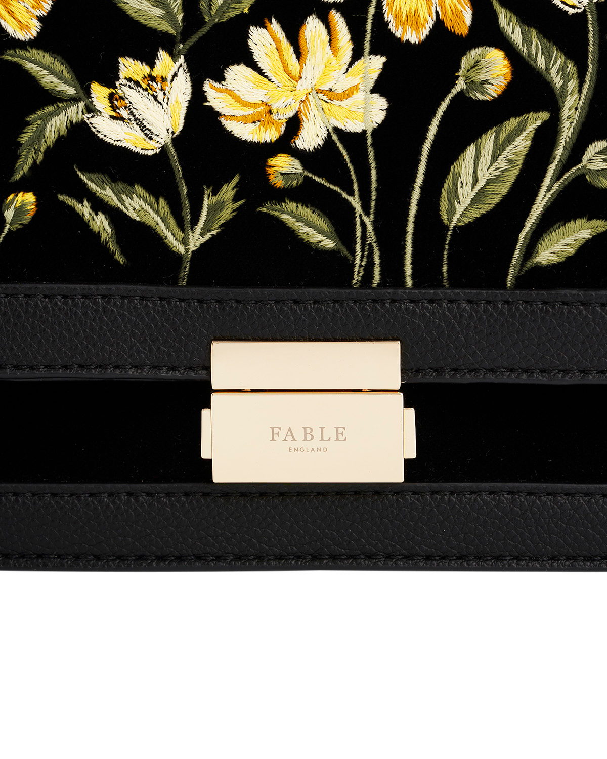 Black pouch with floral embroidery and 'Fable' branding on a white background