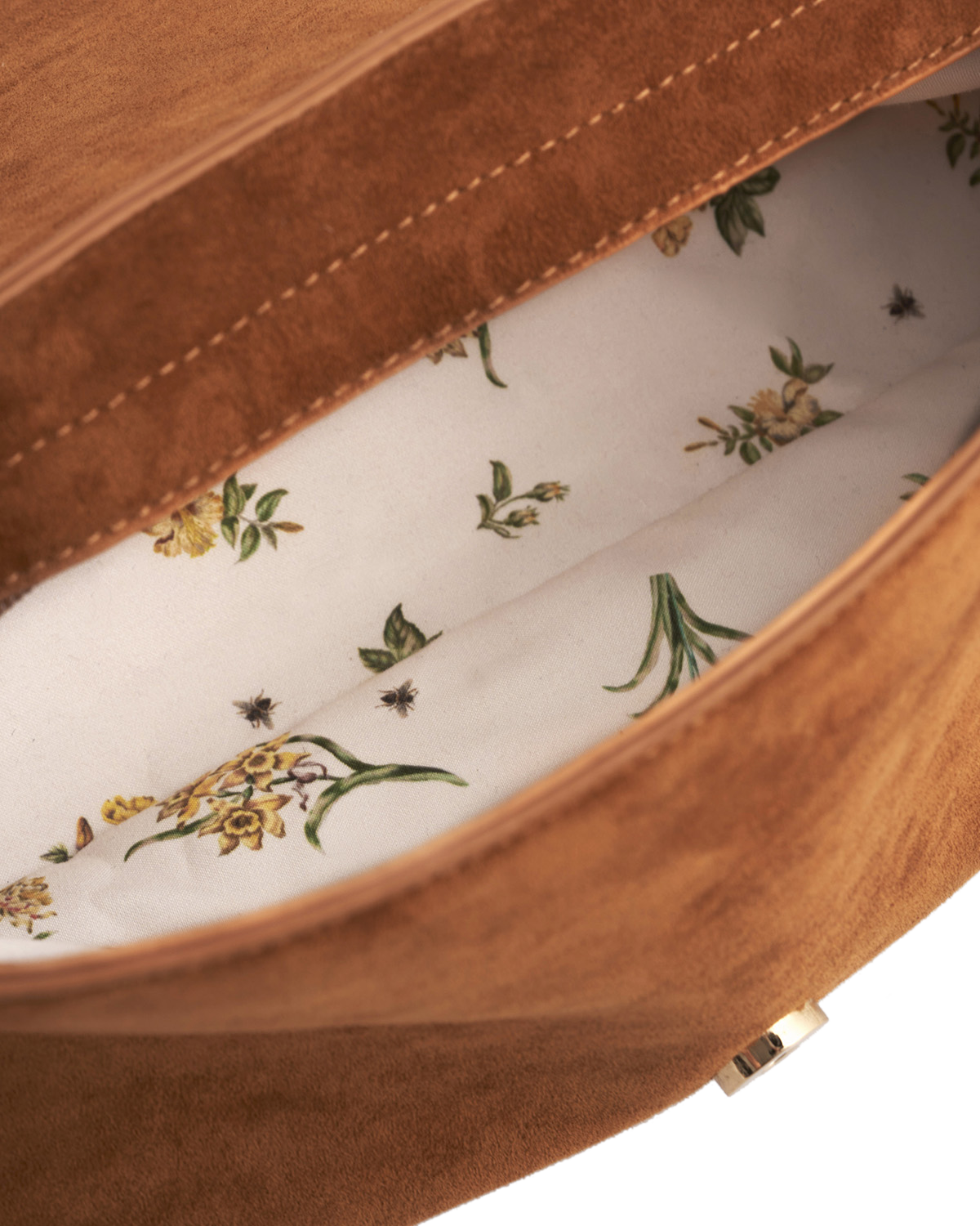 Close-up of a brown leather bag with floral lining