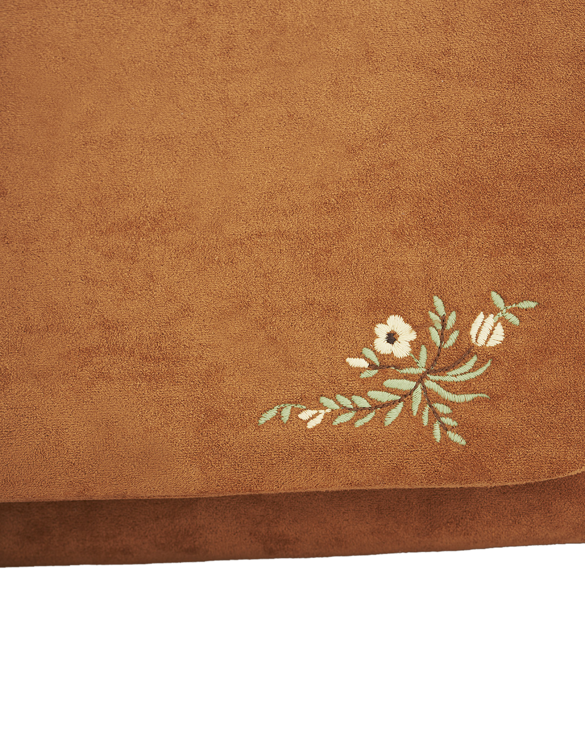 Brown fabric with floral embroidery on a white background