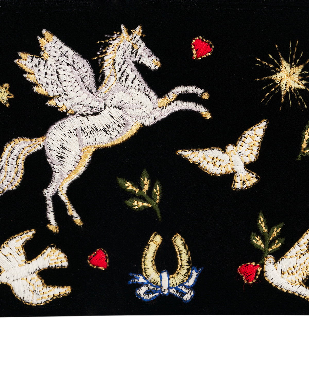 Embroidered design of a pegasus, horseshoe, and hearts on a black background