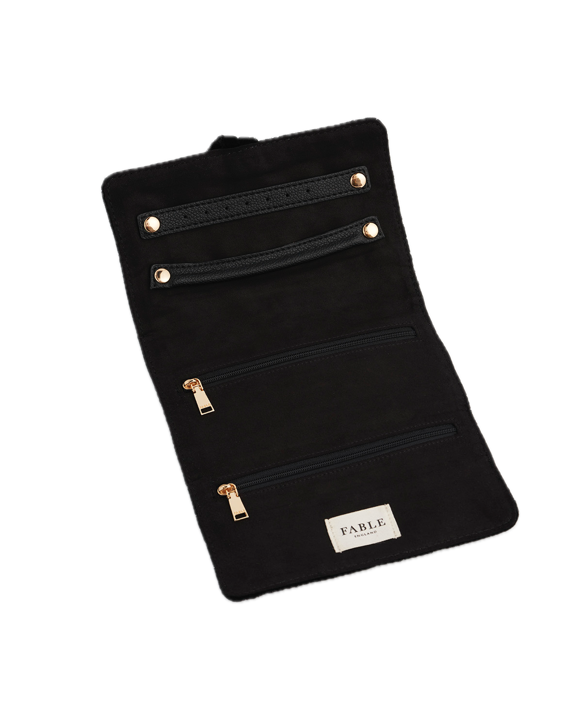 Black velvet jewellery roll with multiple compartments and 'Fable' branding on a white background