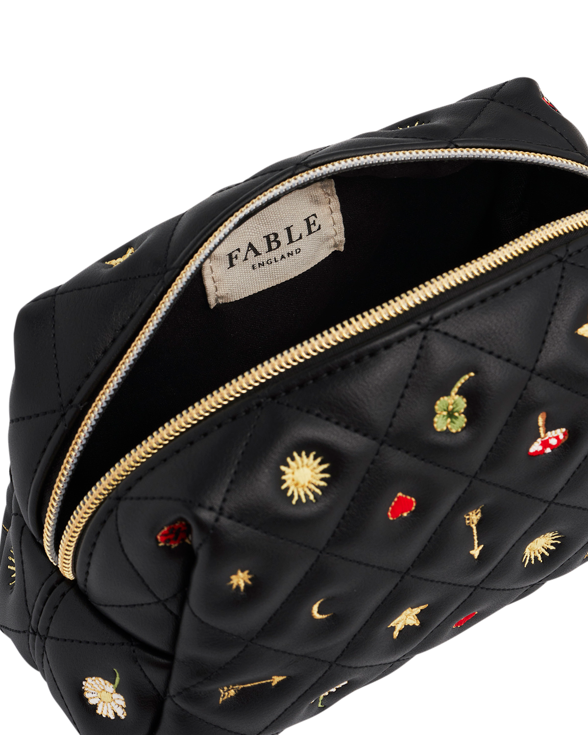 Black quilted pouch with embroidered designs and 'Fable' label on a white background