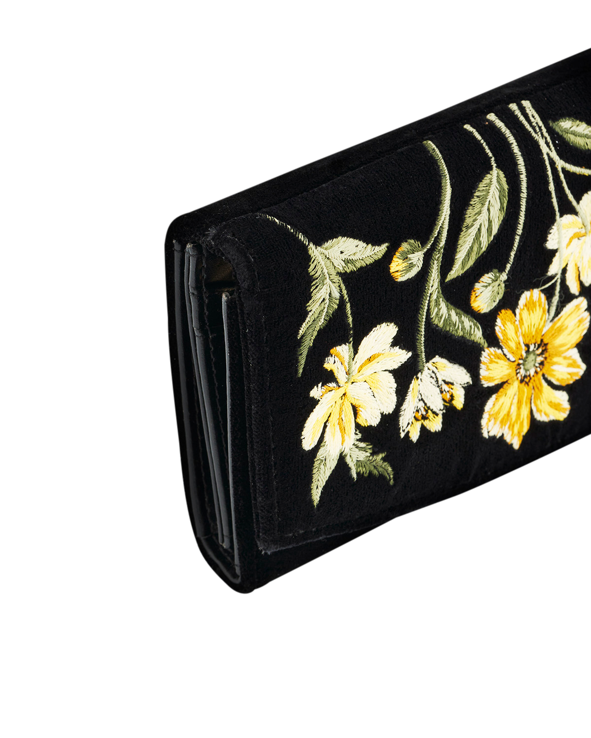 Black clutch with yellow floral embroidery on a white background