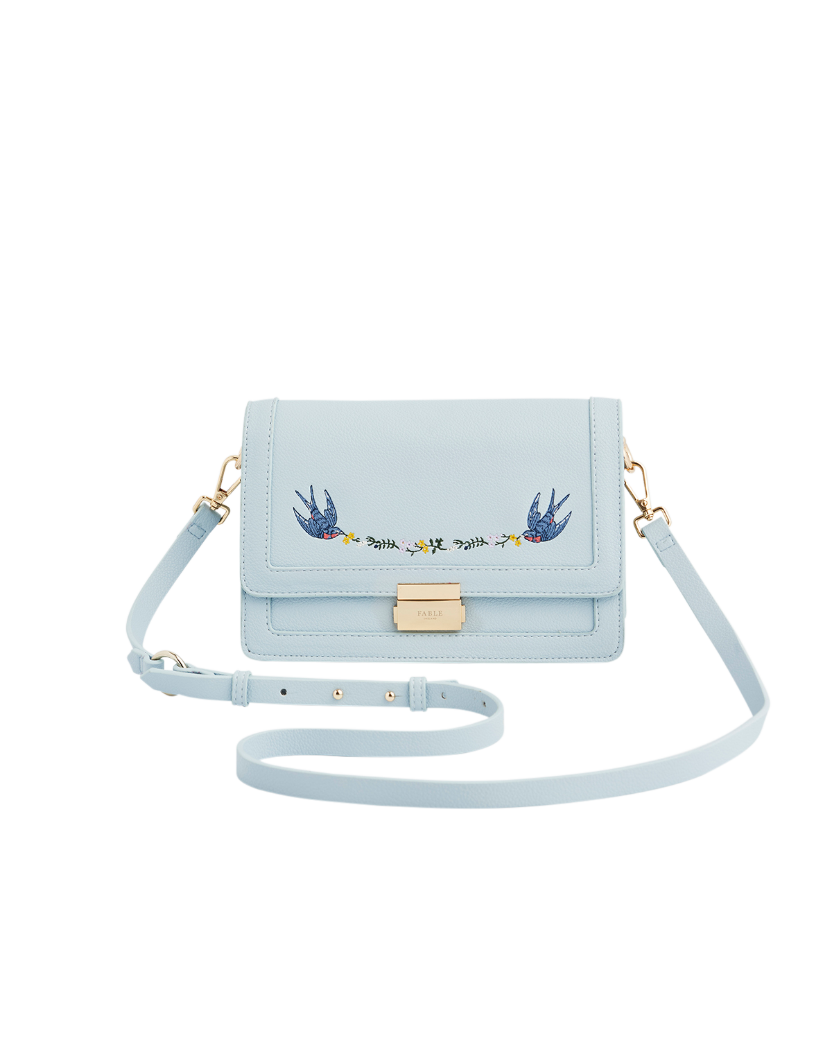 Light blue handbag with embroidered design on a white background