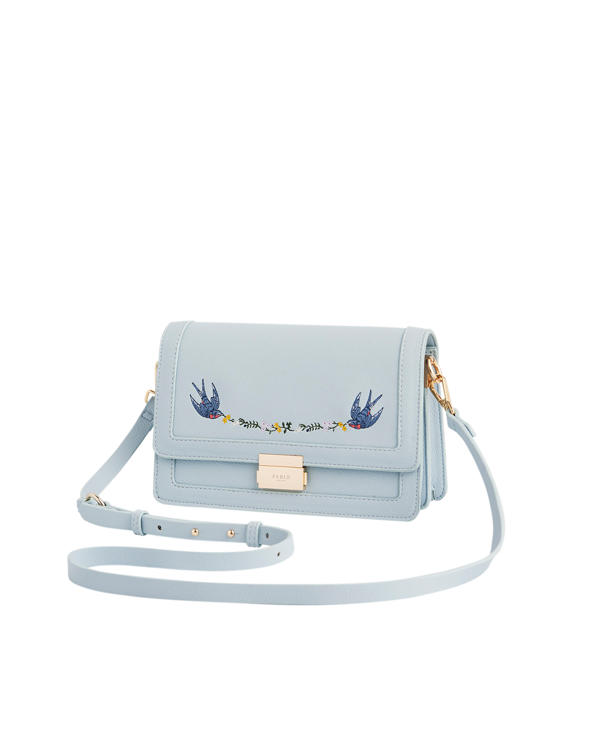 Light blue handbag with embroidered designs on a white background