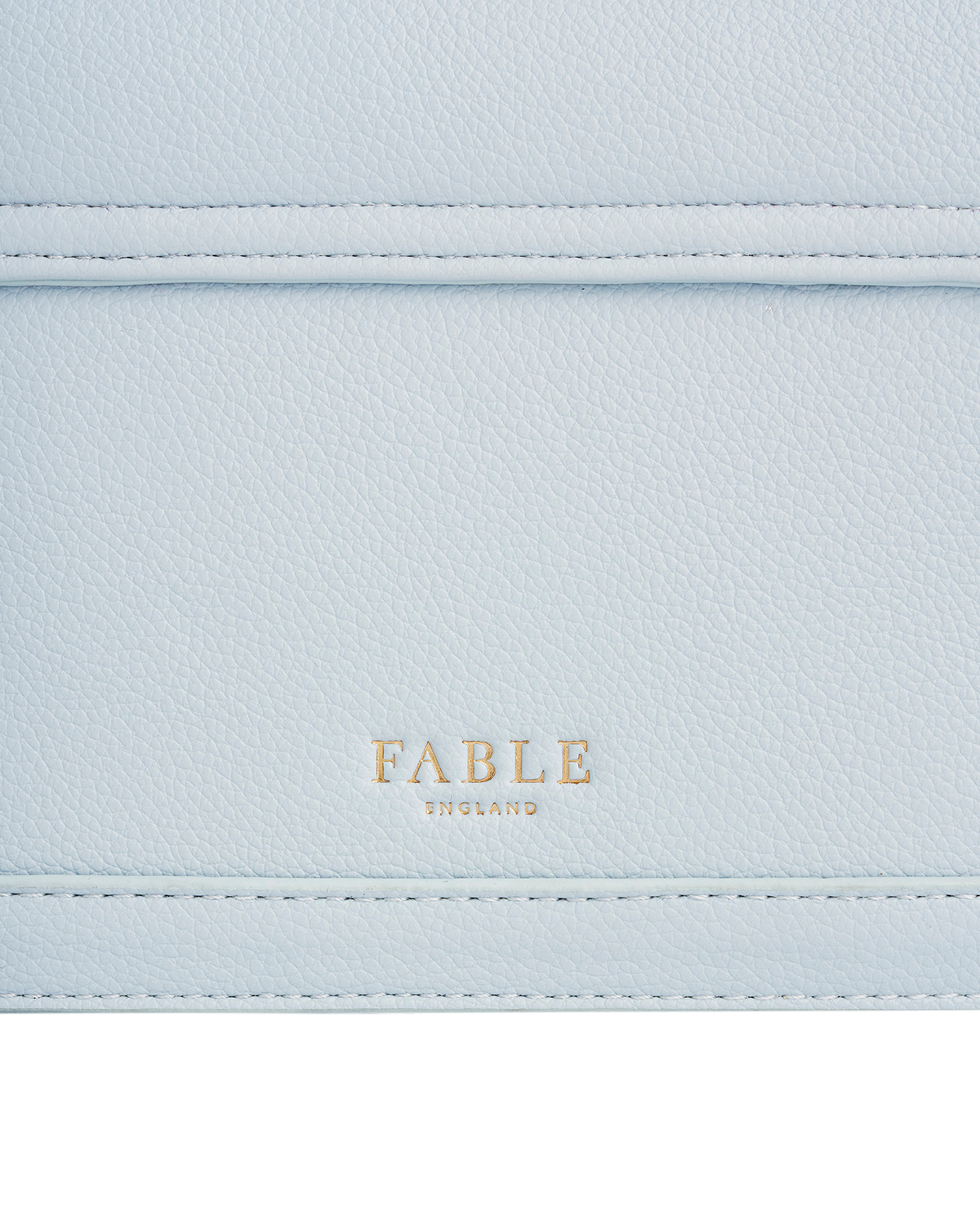 Light blue leather bag with 'Fable' branding on a white background