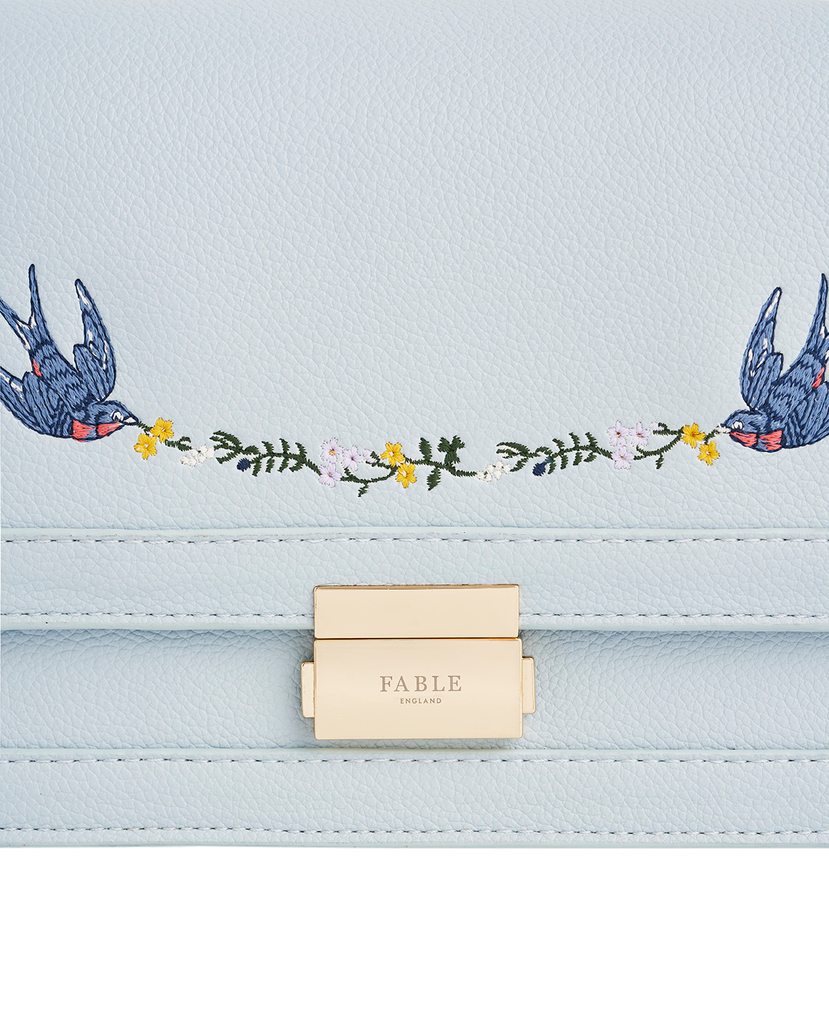 Light blue handbag with embroidered birds and floral details, featuring the brand 'Fable'.