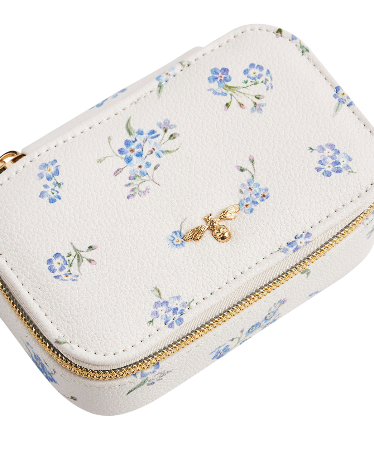 White jewelry box with floral pattern and gold zipper on a white background