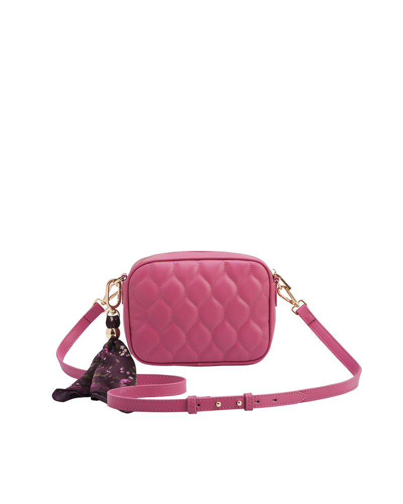 Pink quilted handbag with a matching strap on a white background
