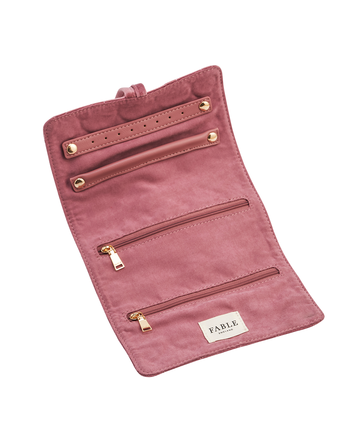 Pink jewellery roll with gold zippers on a white background, featuring the brand 'Fable England'.
