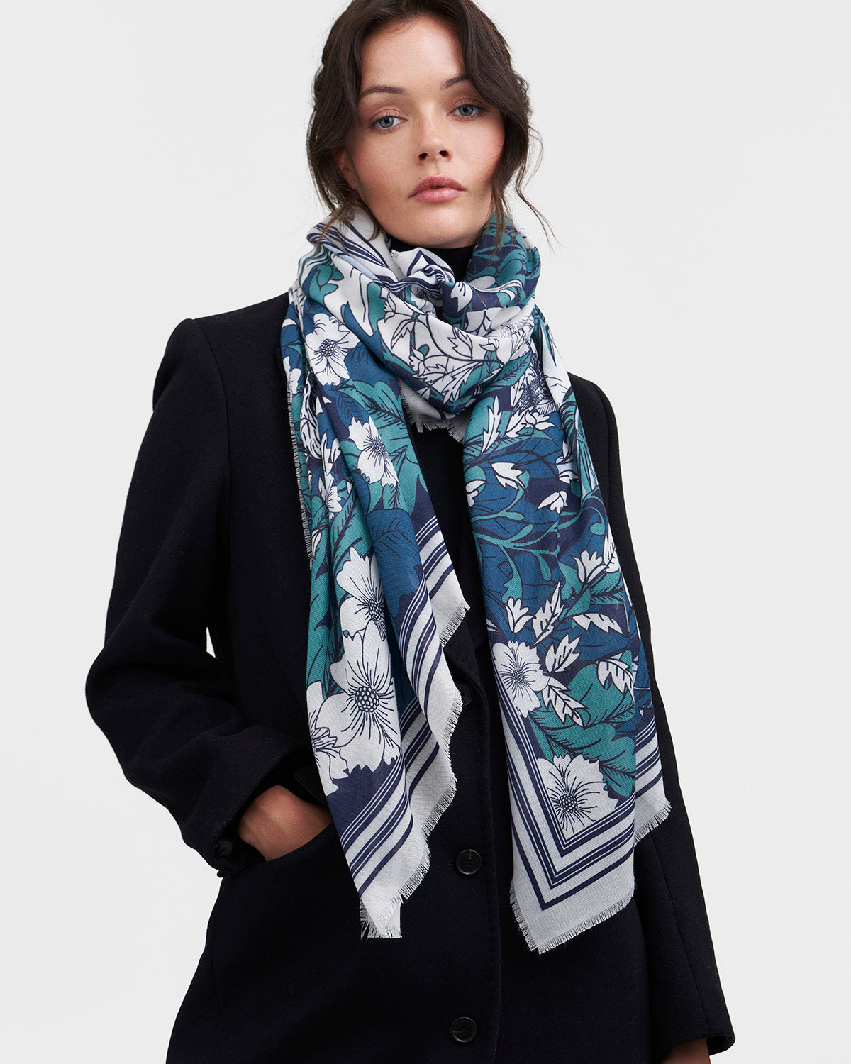 Woman wearing a floral patterned scarf on a white background