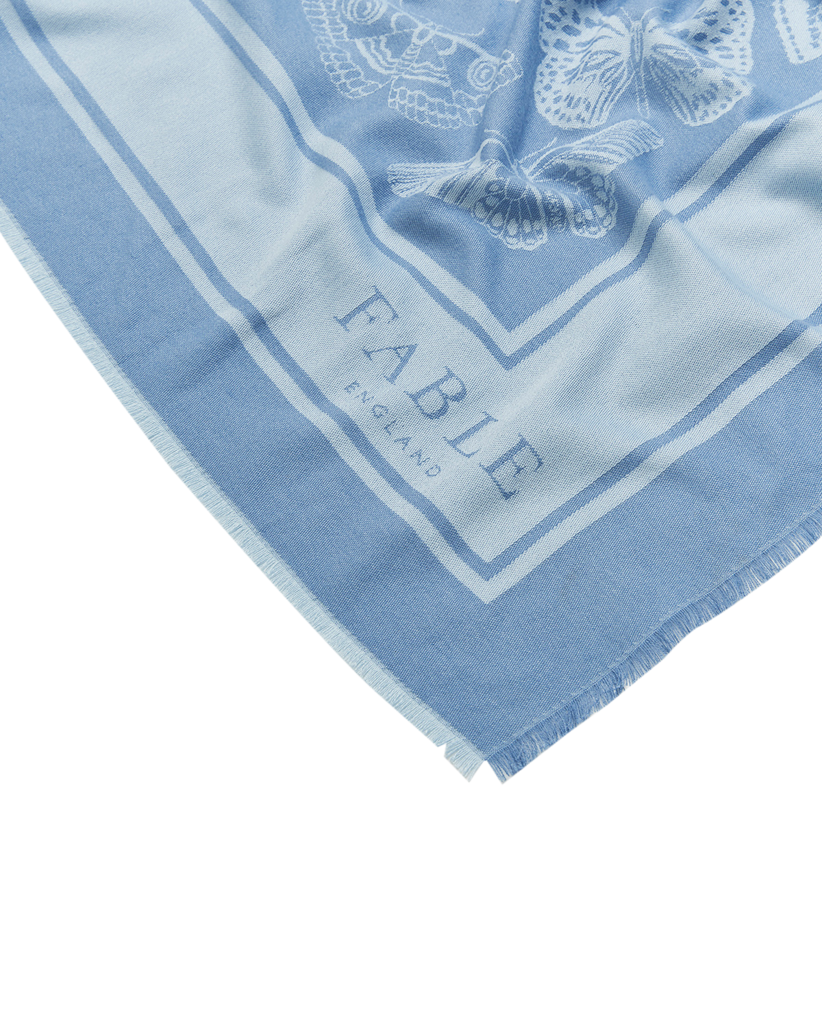 Light blue scarf with white butterfly design and 'Fable' branding on a white background
