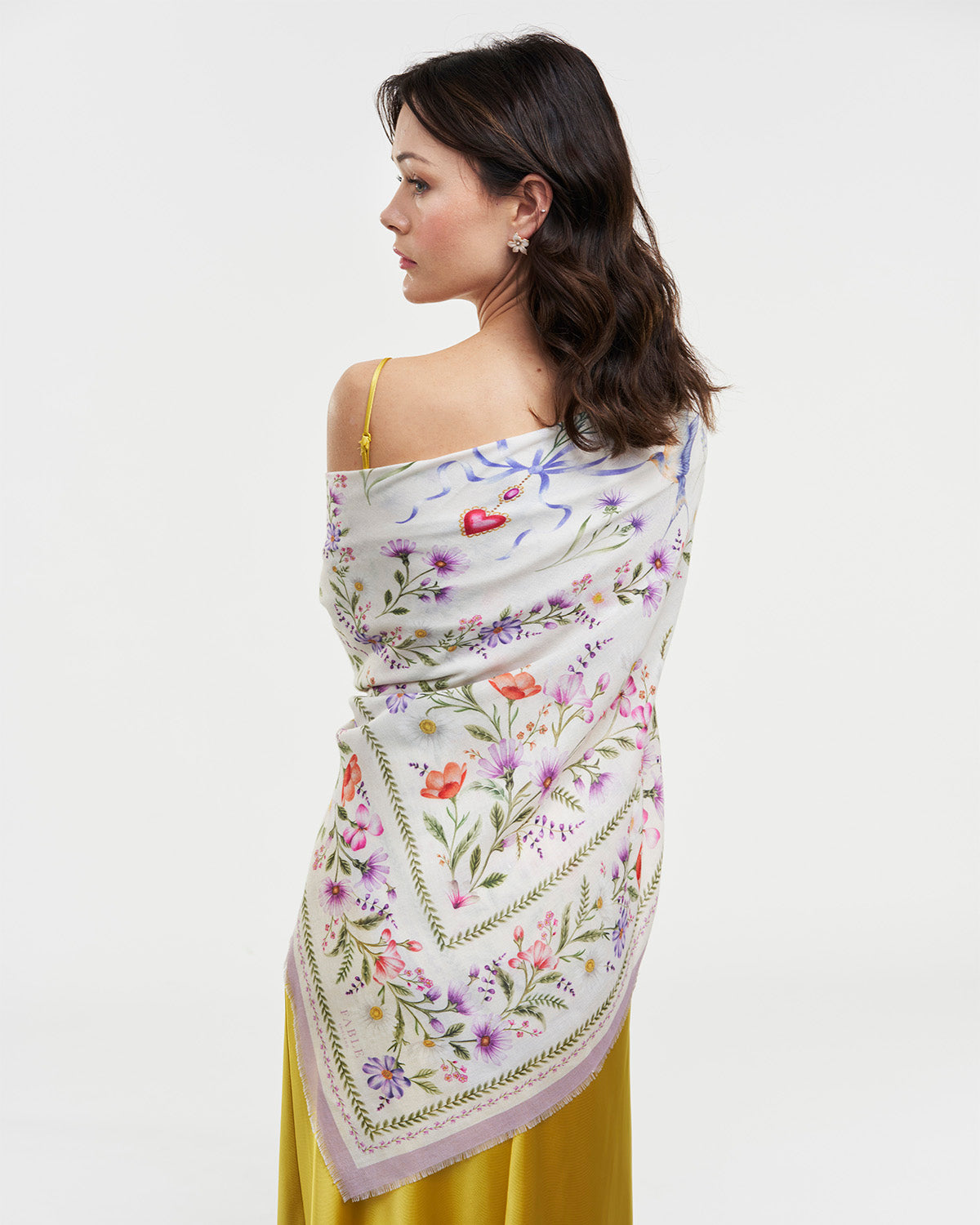 Model wearing Cream Forget Me Knot Narrative Square Scarf with floral print and frayed hems.
