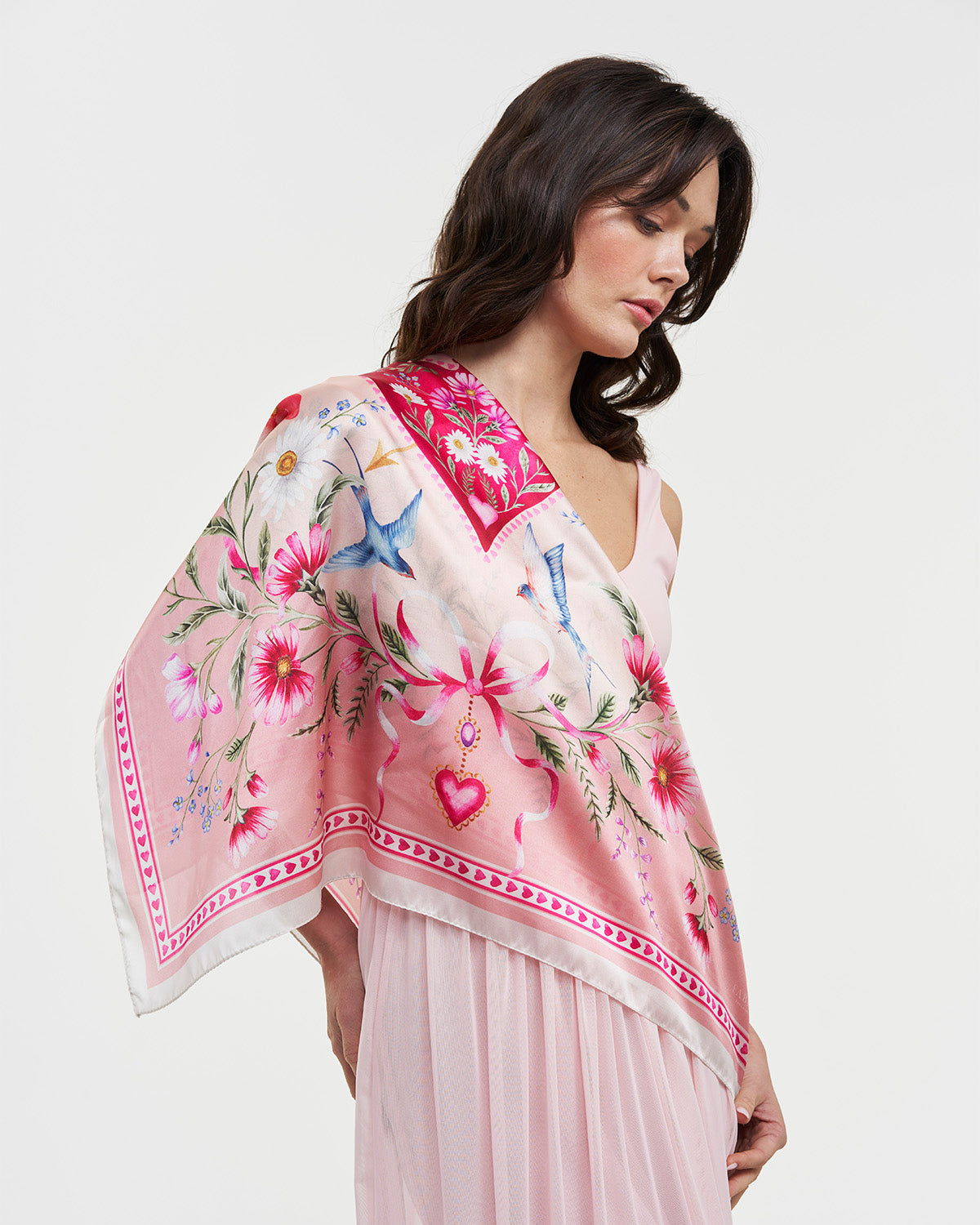 Pink Penelope Square Scarf featuring colorful floral and whimsical designs worn elegantly over a dress.
